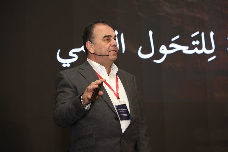 Mohammed Sarrif speaking on stage at a conference